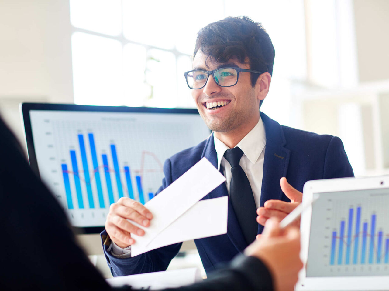 Young businessman offering colleague tickets or coupons to share